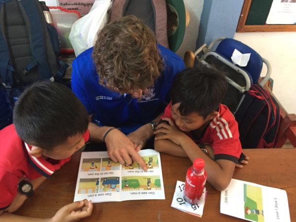 Group of students working on a project together in a classroom setting.